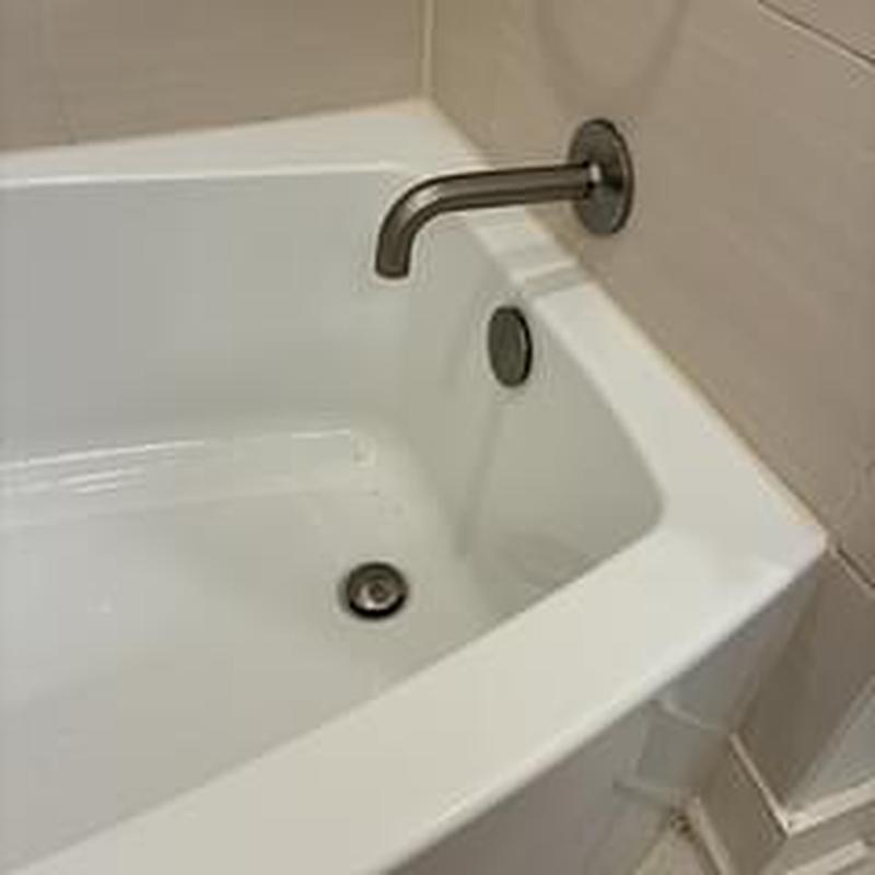 Bathtub drain and spout in basement bathroom Bathtub drain and spout in basement bathroom