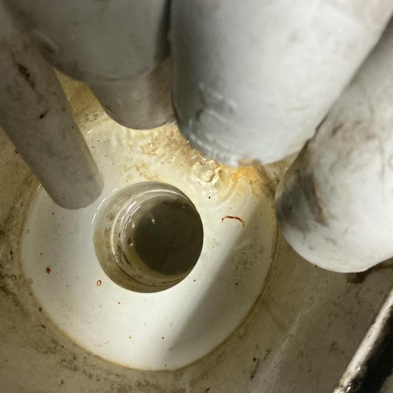 Drain piping inside cleanout showing clear flow and no blockages Drain piping inside cleanout showing clear flow and no blockages
