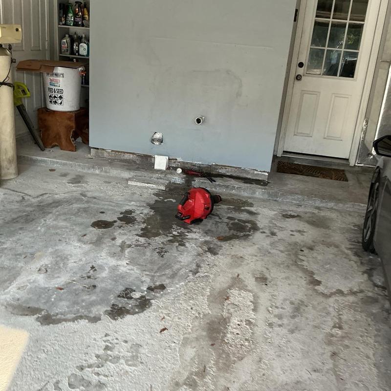 Laundry drain line with plumber snake and water stains Laundry drain line with plumber snake and water stains