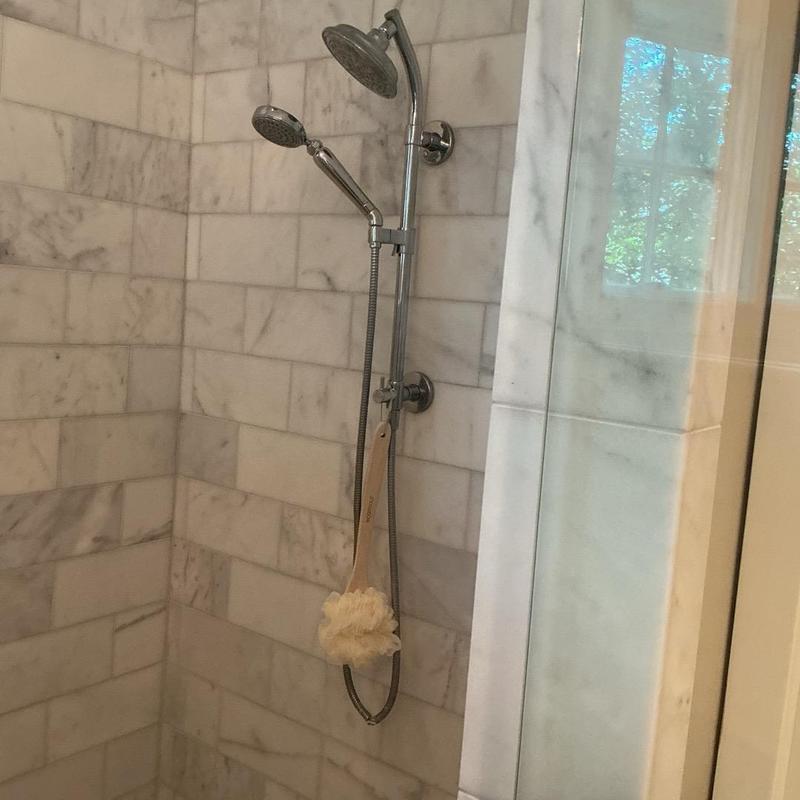 Shower trim and dual shower heads in tiled shower Shower trim and dual shower heads in tiled shower