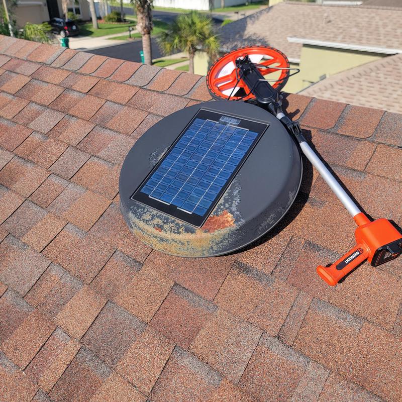 Solar attic fan with rusty corrosion on roof shingles Solar attic fan with rusty corrosion on roof shingles