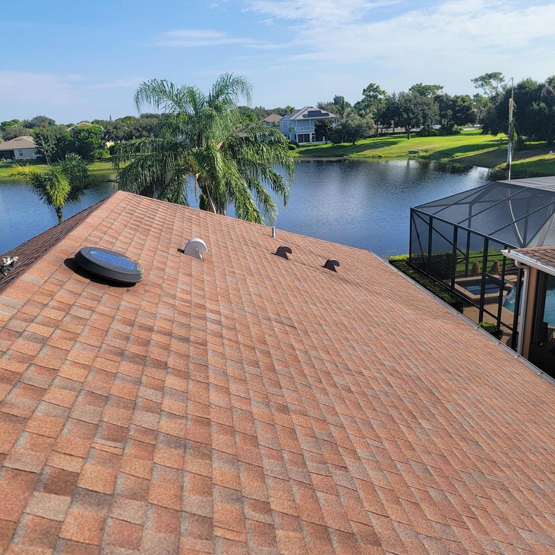 Asphalt shingle roof with vent pipes near water view Asphalt shingle roof with vent pipes near water view
