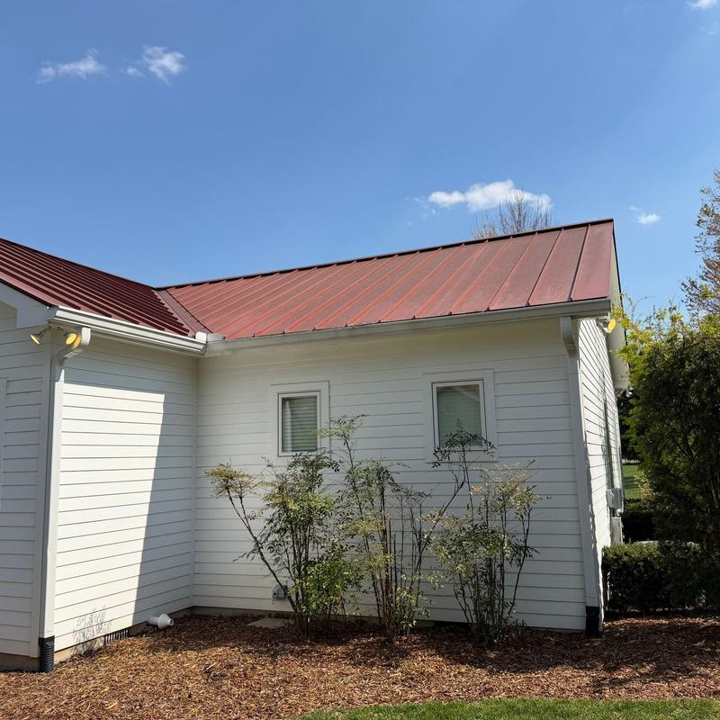 Metal roof panels with visible rust spots and damage