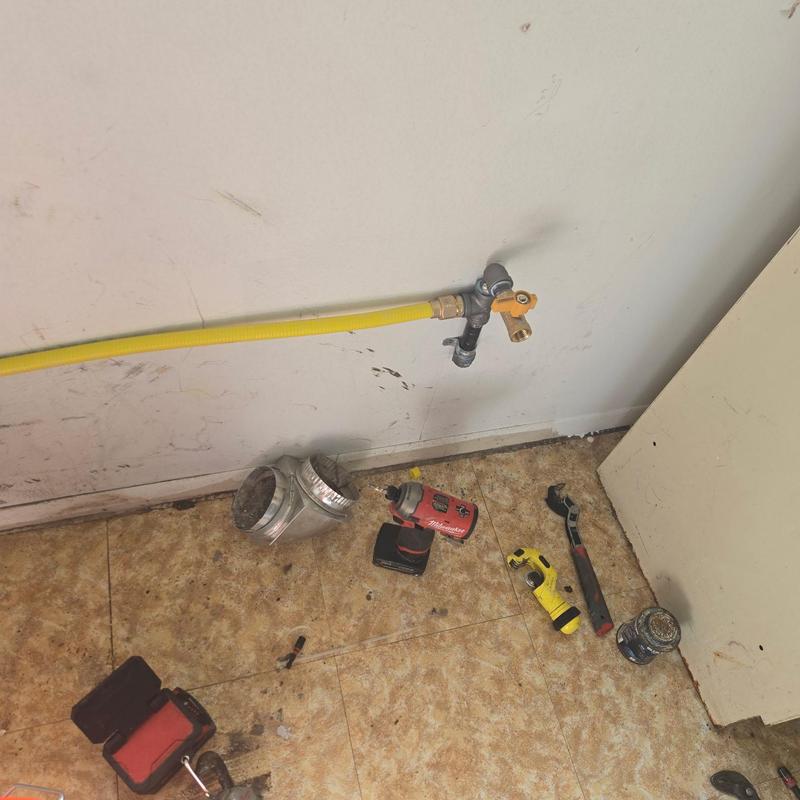Gas line installation with tools on floor