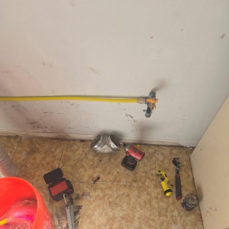 Gas line installation with yellow piping and tools