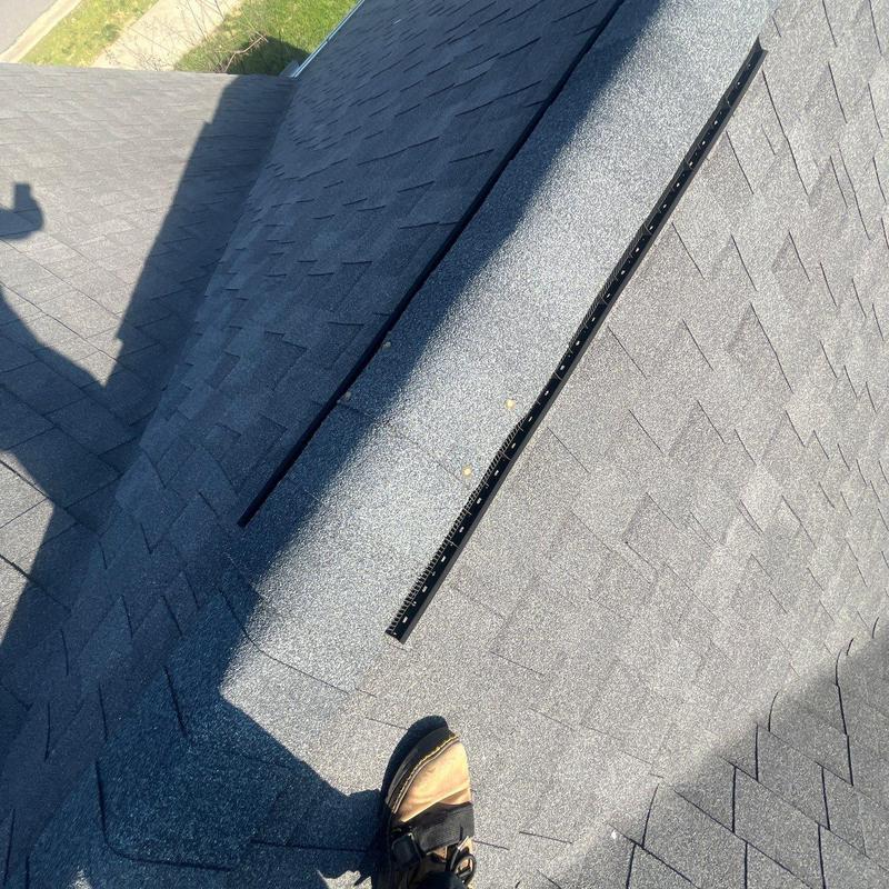 Asphalt shingle roof with hail damage inspection