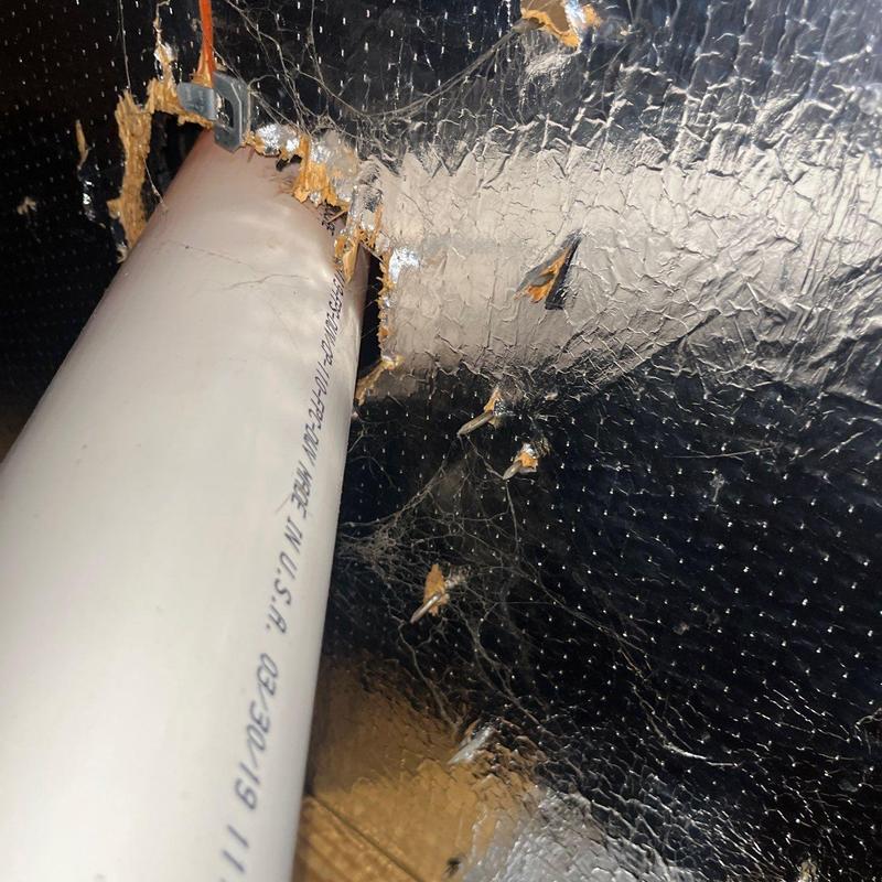 Insulation board and PVC pipe with damage and cobwebs