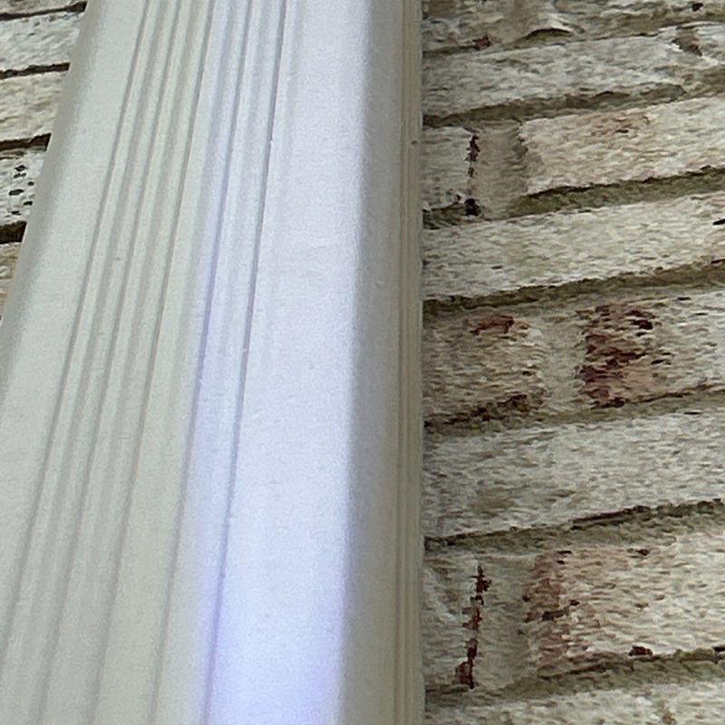 Gutter downspout close-up against brick wall