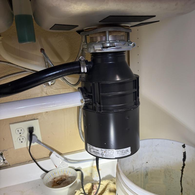 Garbage disposal unit installed under kitchen sink Garbage disposal unit installed under kitchen sink