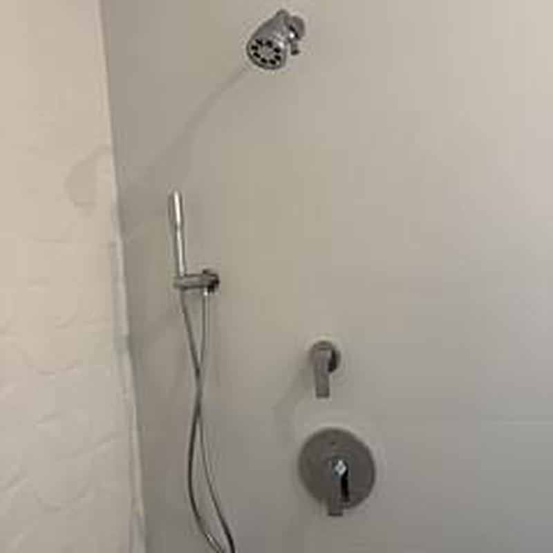 Shower head and trim installed in bathroom remodel