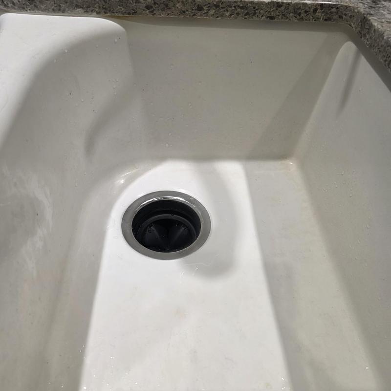 Garbage disposal drain and white kitchen sink interior