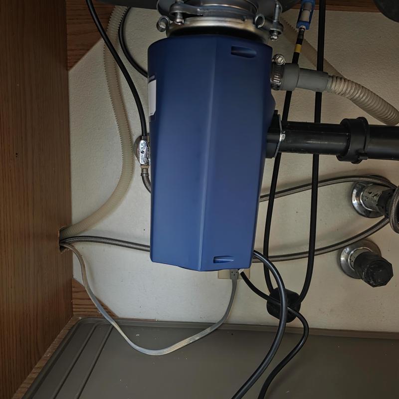 Garbage disposal unit under kitchen sink installation