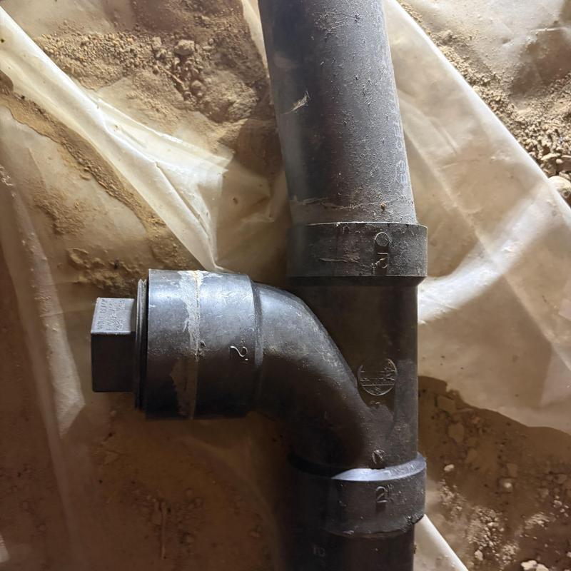 ABS kitchen drain piping with elbow joint on dirt floor ABS kitchen drain piping with elbow joint on dirt floor