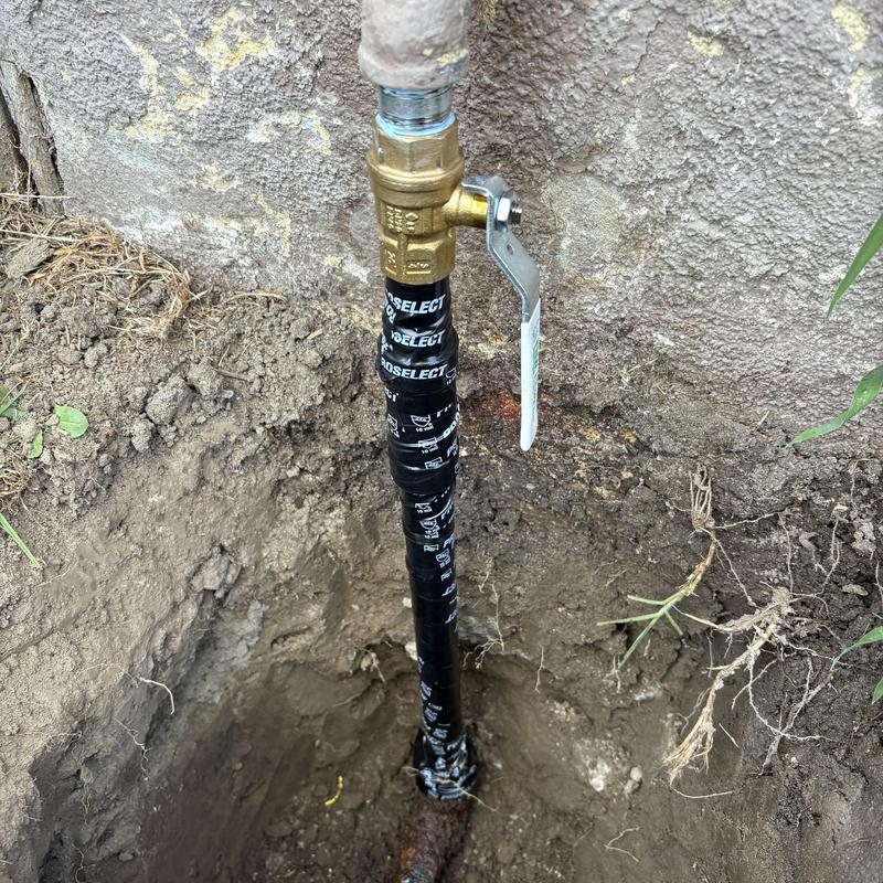 3/4-inch gas pipe with new shut-off valve in dirt hole