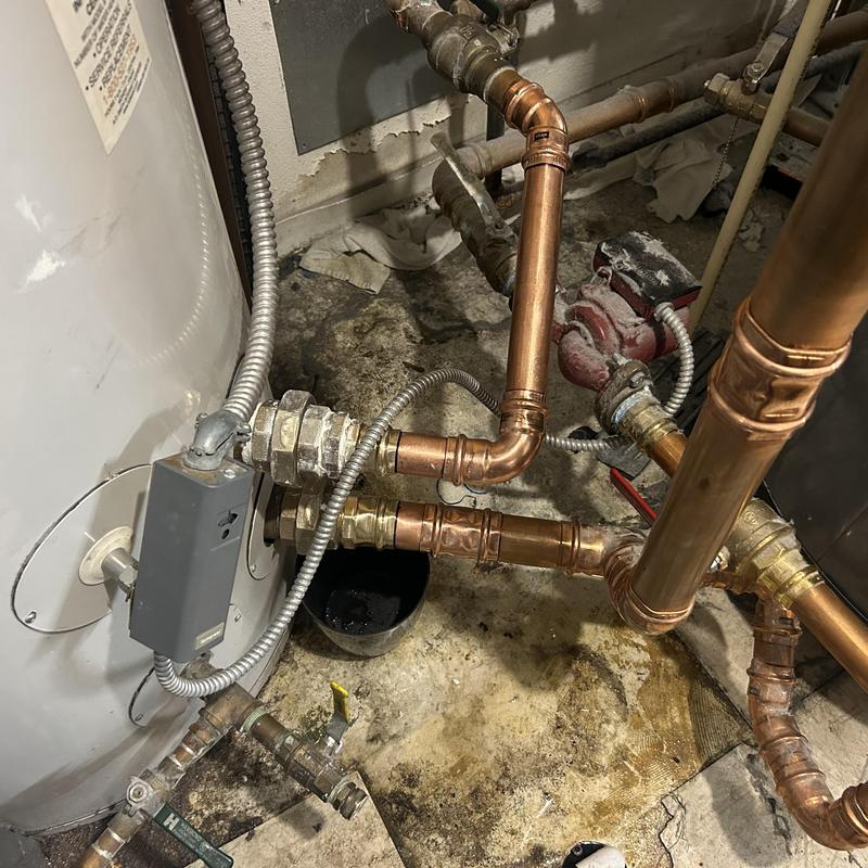 Boiler holding tank with copper piping and valves Boiler holding tank with copper piping and valves