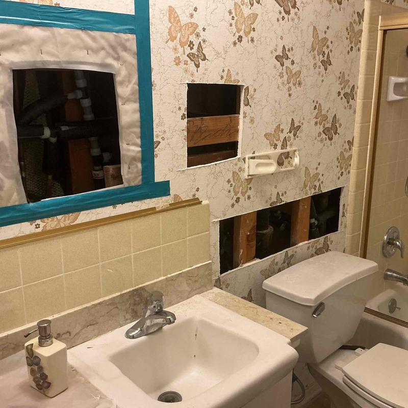 Water piping with wall access holes in bathroom