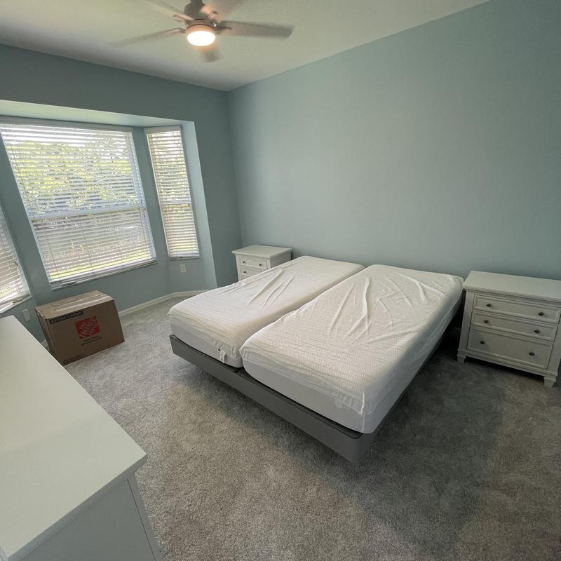 Twin bed frames and mattress setup in bedroom