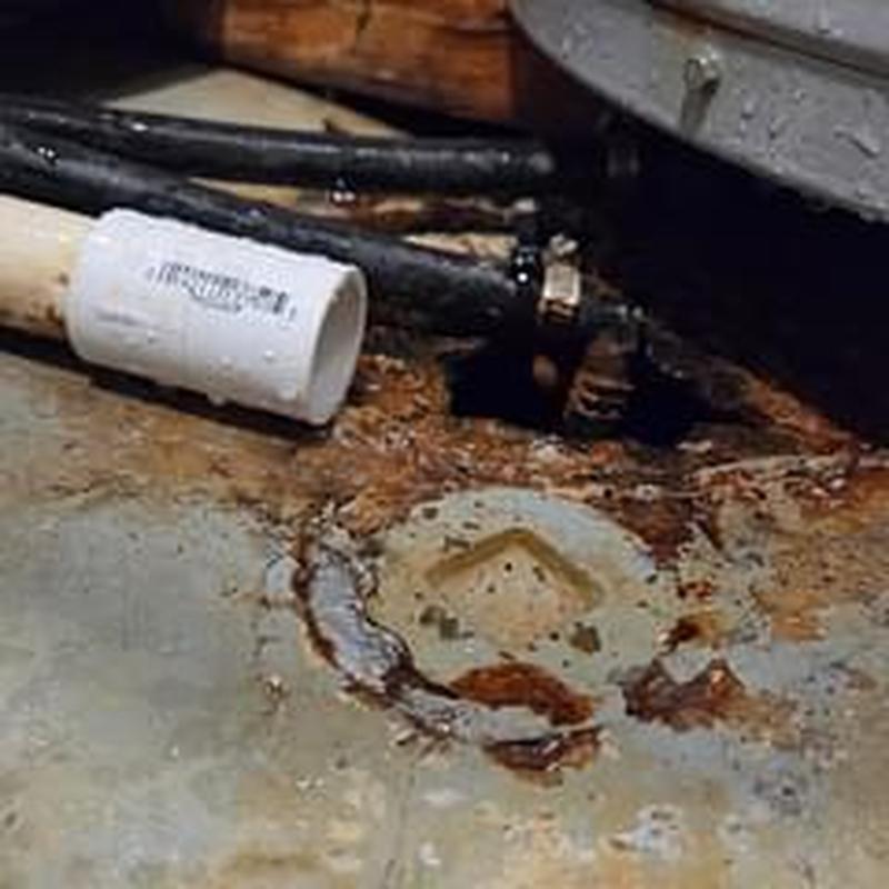 Water softener drain with disconnected pipe and rust stains Water softener drain with disconnected pipe and rust stains