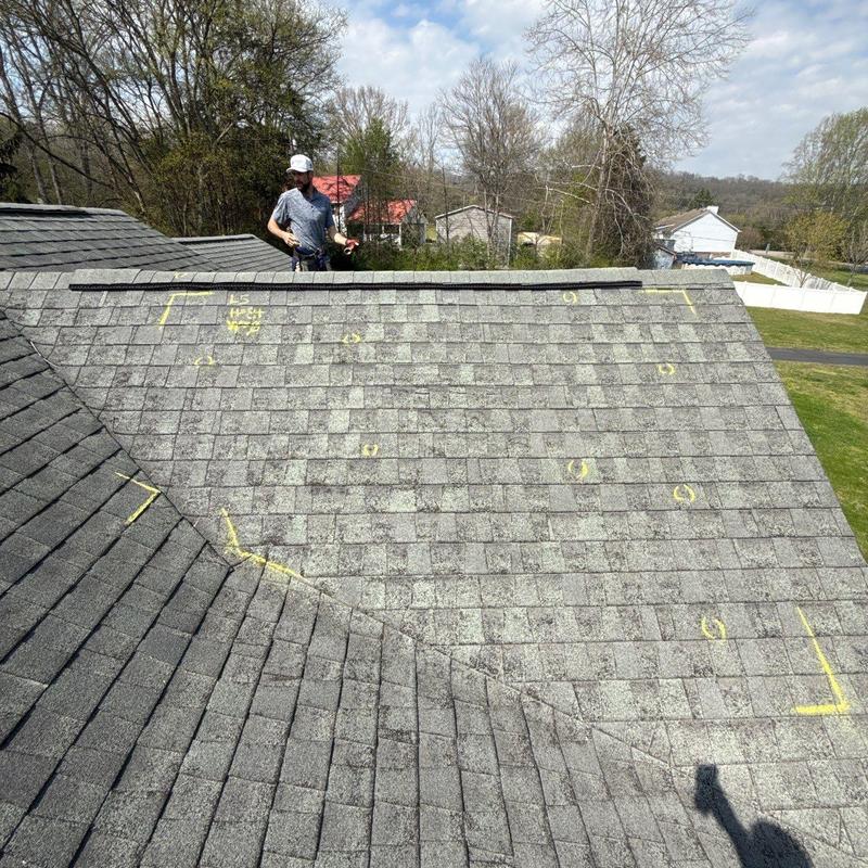 Roof shingles marked for hail damage inspection