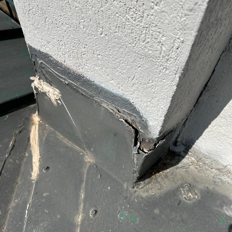 Metal roof flashing with cracked sealant damage