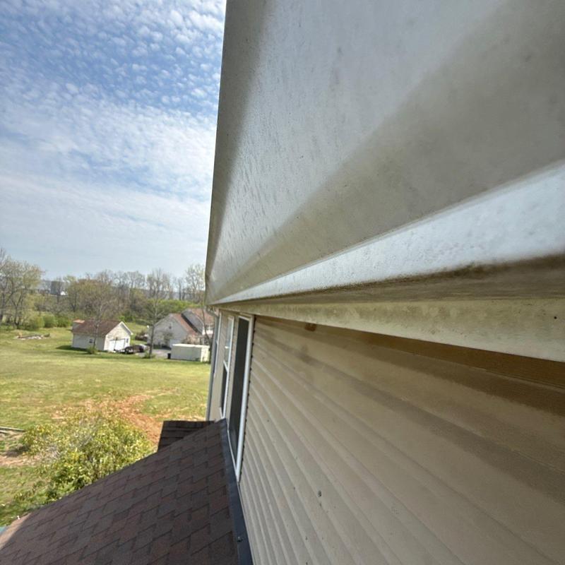 Vinyl siding and gutter installation on house exterior