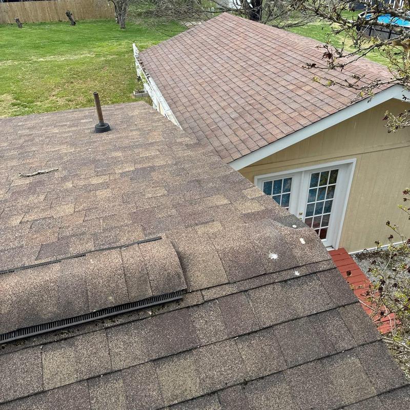 Asphalt shingle roof with hail damage inspection