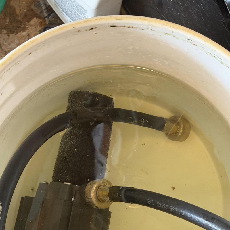 Water softener tubing soaking in descaling solution Water softener tubing soaking in descaling solution