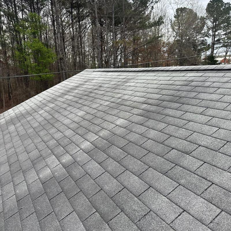 Asphalt shingles with visible hail damage on roof