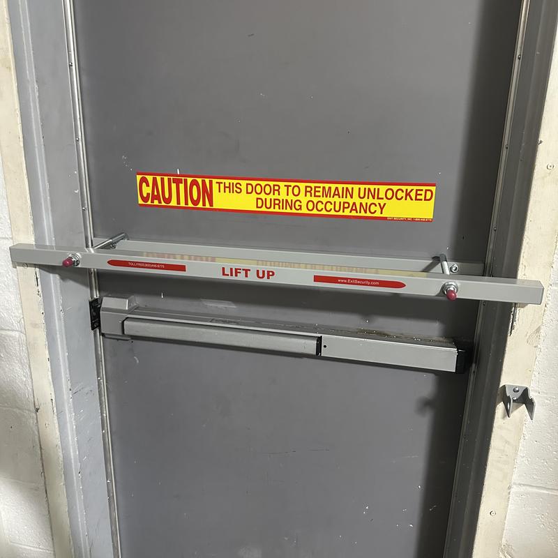 Exit security bar installed on gray metal door Exit security bar installed on gray metal door