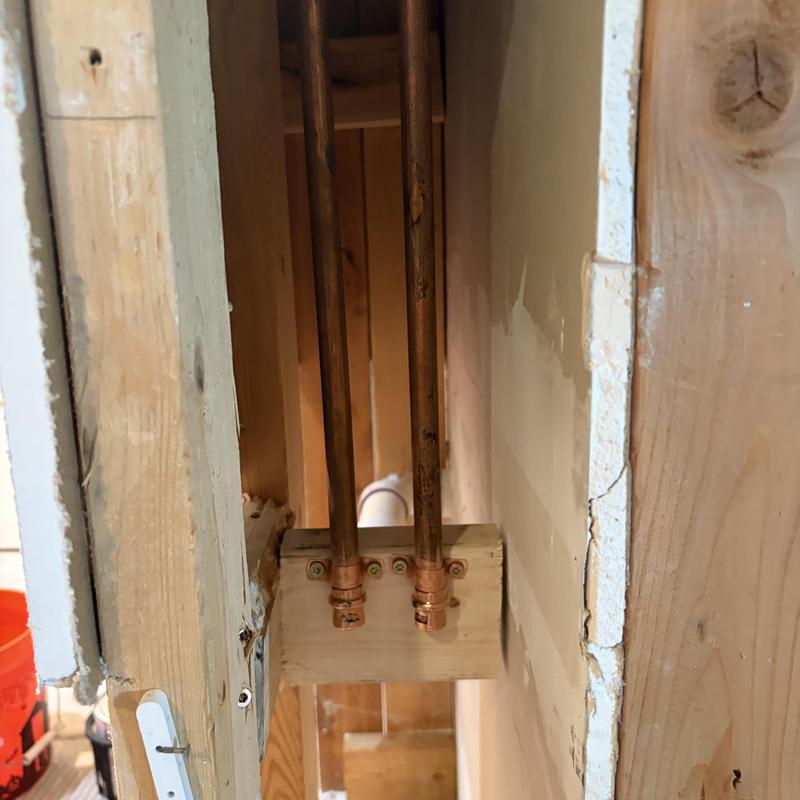 12-inch copper water lines capped and mounted in wall