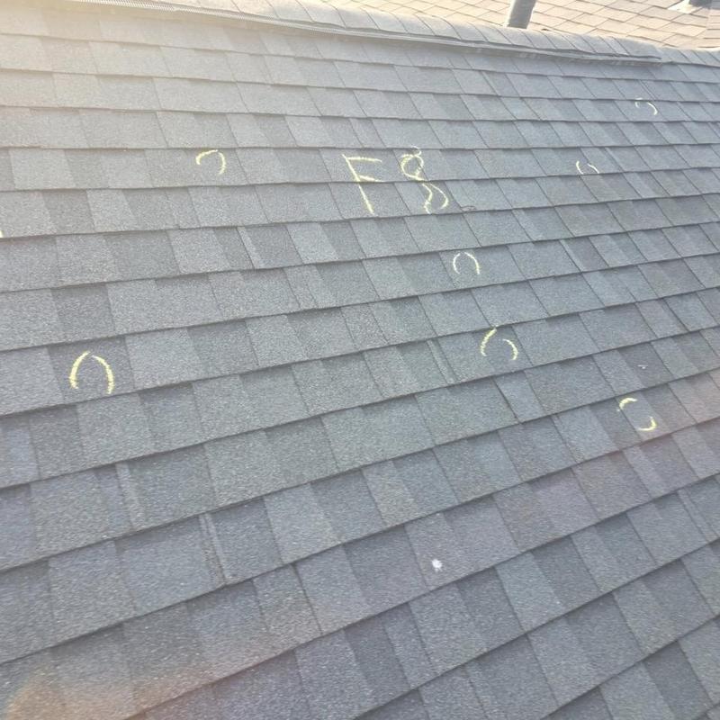 Roof shingles with hail damage marked in chalk