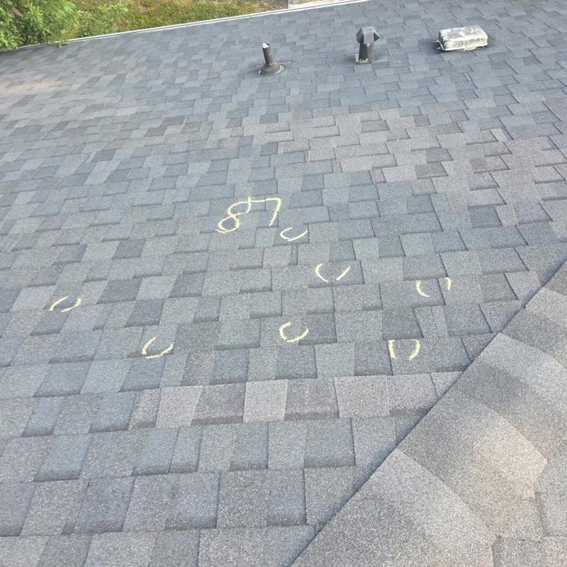 Roof shingles with marked hail damage spots