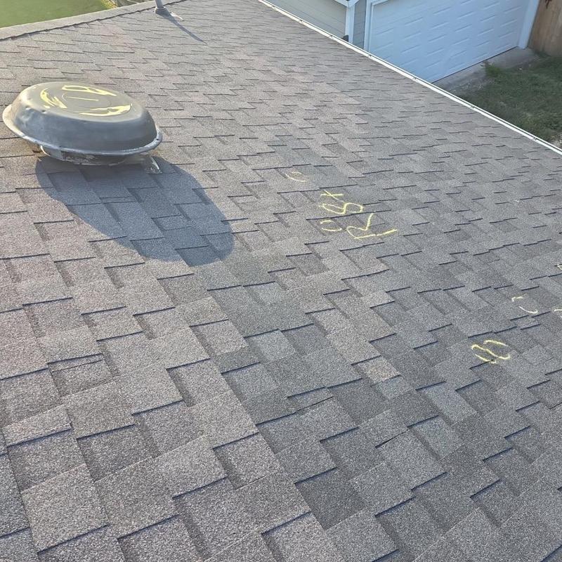 Roof shingles with marked hail damage on Pearland home