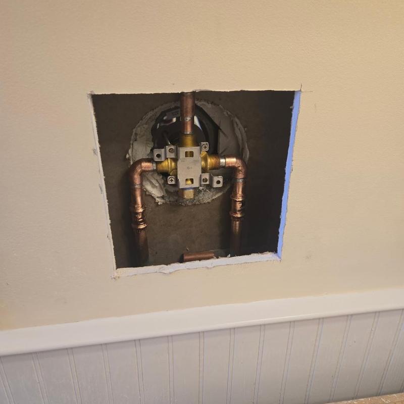 Shower valve with copper piping installed in wall cavity