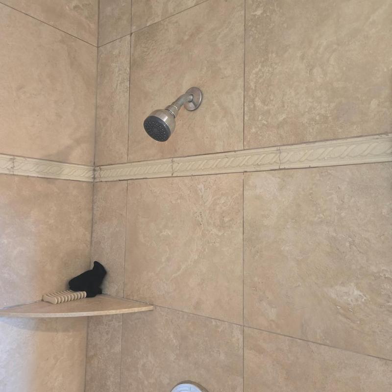 Shower valve with tiled wall and corner shelf