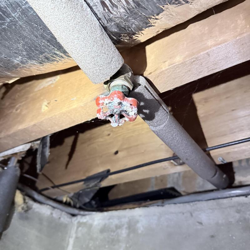 Silcock valve with pipe insulation in basement ceiling