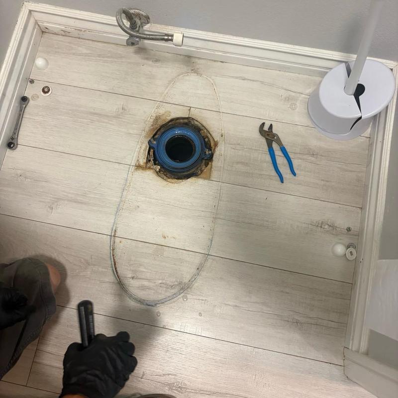 Master bathroom toilet flange with tools and gloves
