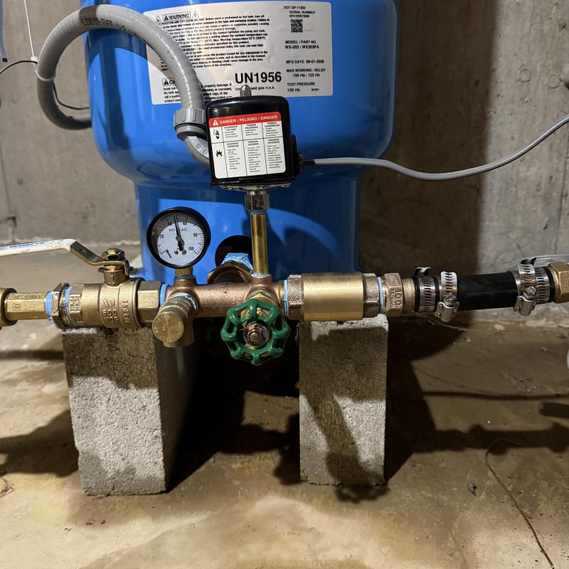Well tank pressure gauge and valve installation in basement