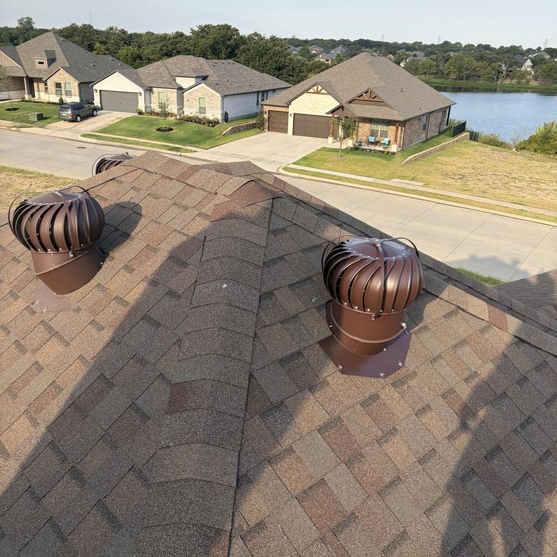 Roof ventilation turbines on asphalt shingle roof
