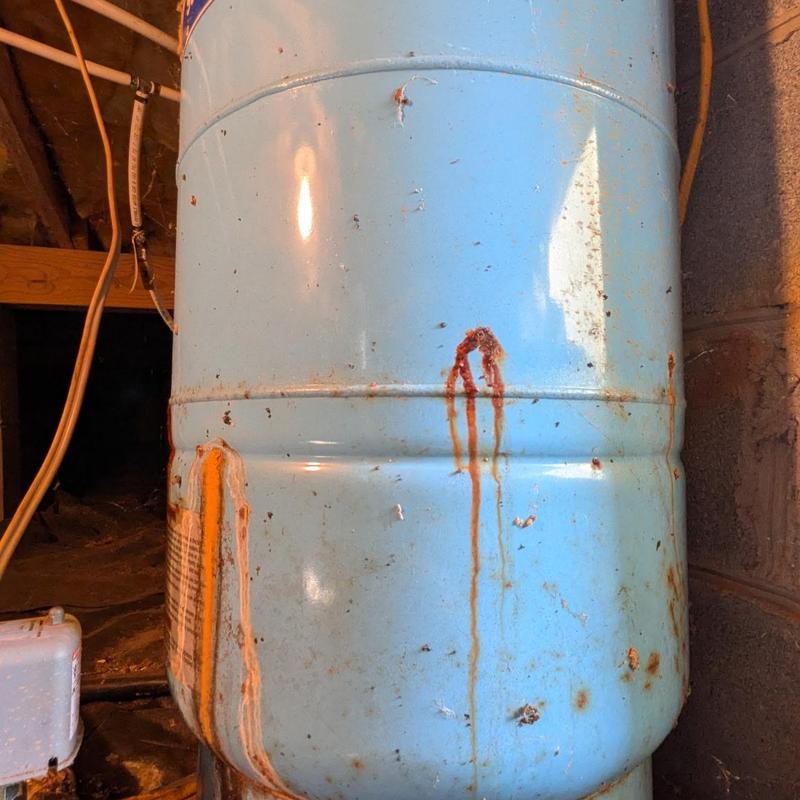 Well pressure tank with rust and corrosion stains Well pressure tank with rust and corrosion stains