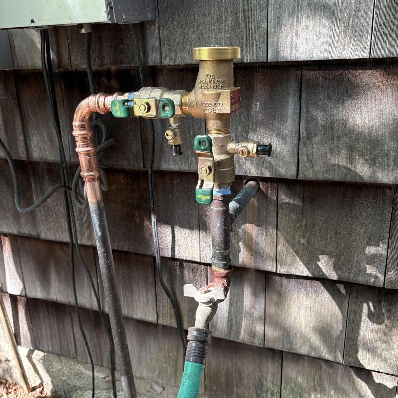 Pressure vacuum breaker backflow device with valve outdoors