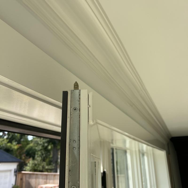 Multipoint lock system on white patio door frame Multipoint lock system on white patio door frame