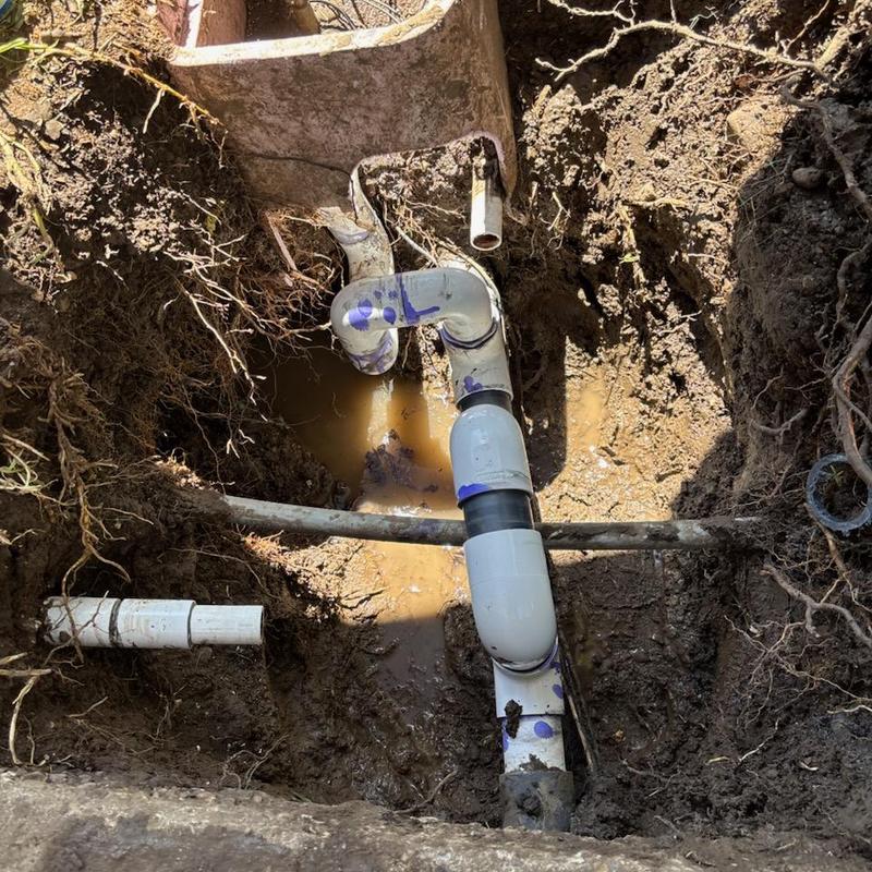 High side irrigation PVC piping repair in muddy trench