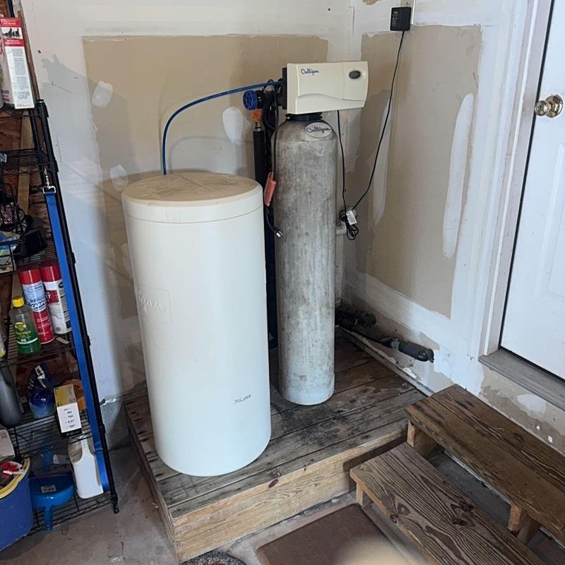 Culligan water softener system in garage corner