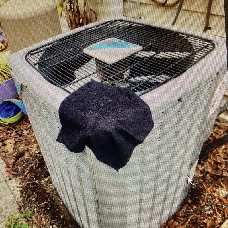 Air conditioner unit with maintenance cloth on top outdoors Air conditioner unit with maintenance cloth on top outdoors