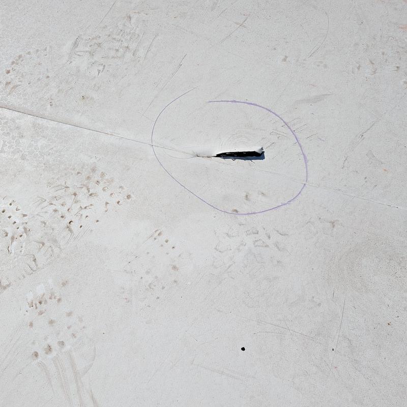 TPO roofing membrane tear with marked damage area