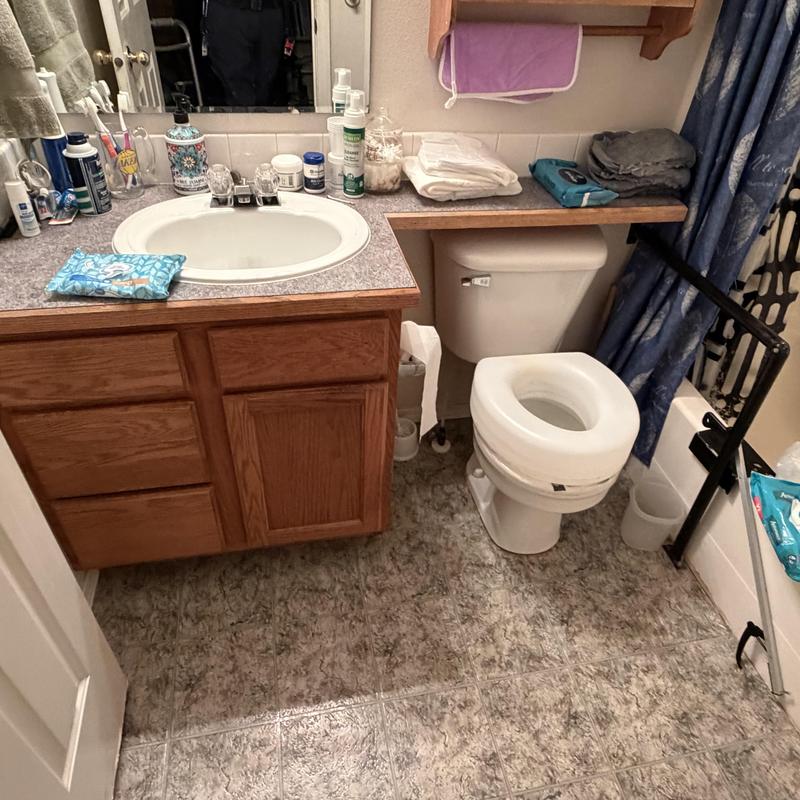 Bathroom vanity and toilet with countertop and floor