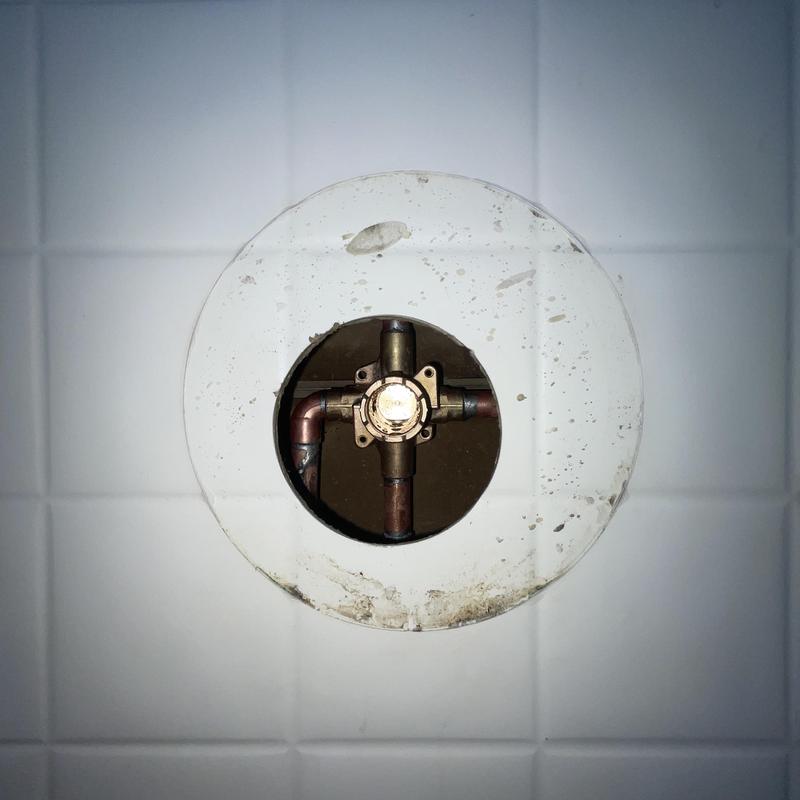 MOEN shower valve plumbing with copper pipes and tile wall