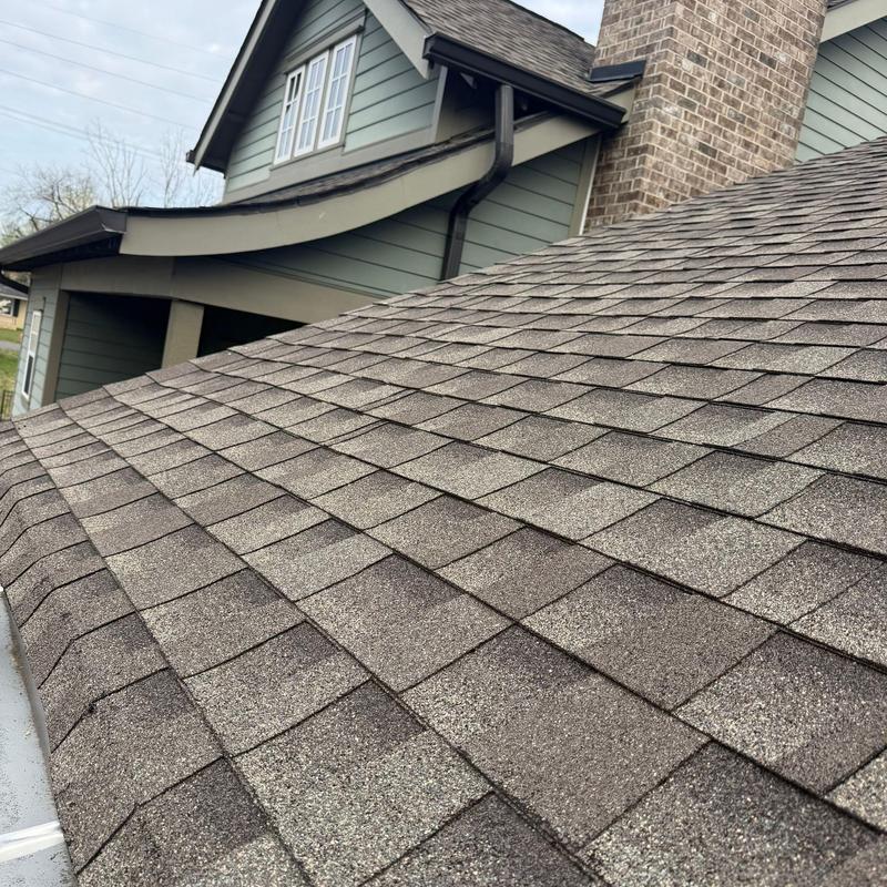 Asphalt roof shingles with hail damage and granule loss