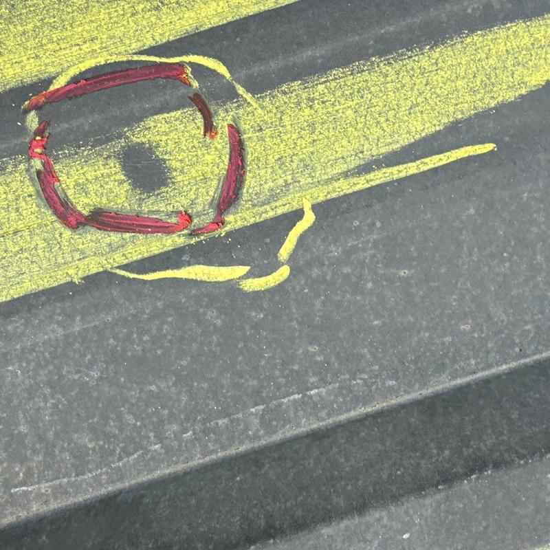 Roof shingle hail damage marked with paint